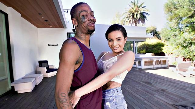 Watch this tattooed brunette get her trimmed pussy drilled by a huge black cock in the living room