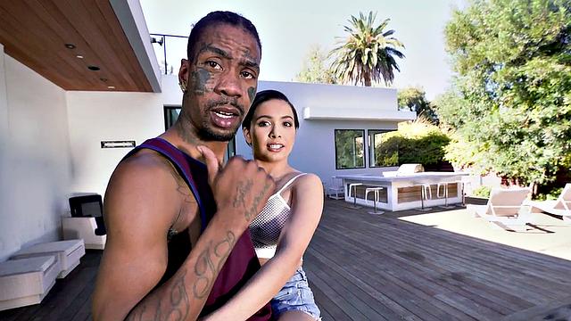 Watch this tattooed brunette get her trimmed pussy drilled by a huge black cock in the living room