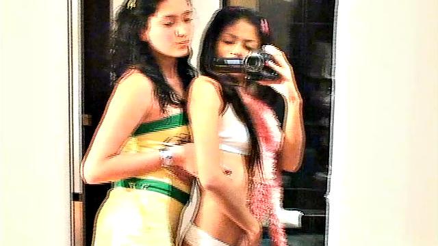 Carina 18 with lesbian babe selfie in front of mirror. They expose tits and get naughty pose