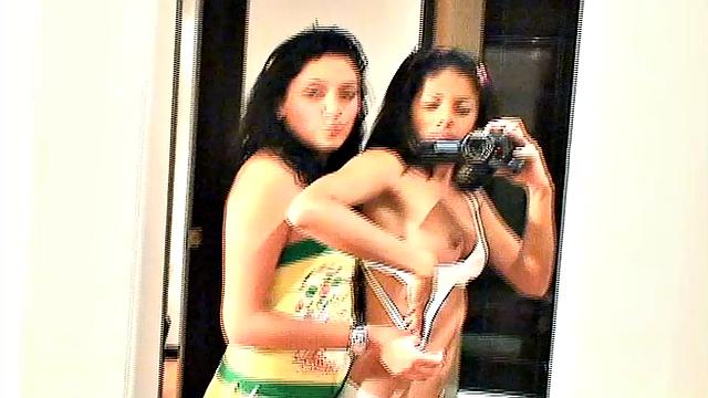 Carina 18 with lesbian babe selfie in front of mirror. They expose tits and get naughty pose