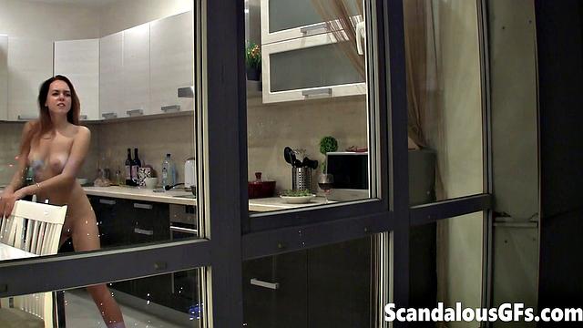 Watching my neighbor's sexy girlfriend goofing around naked in the kitchen