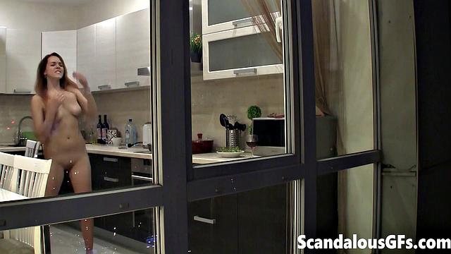 Watching my neighbor's sexy girlfriend goofing around naked in the kitchen
