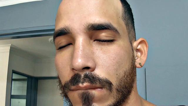 Leon stands in a door way and starts getting himself hard, as he strips. Naked and sporting a big boner, the horny Latino moves to a bed and starts jerking off.