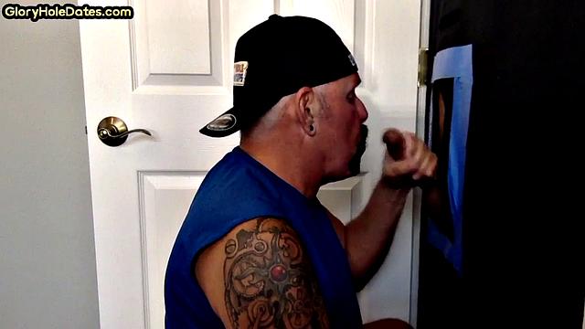 Tattooed gloryhole DILF sucks and wanks cock