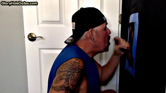 Tattooed gloryhole DILF sucks and wanks cock