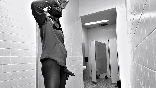 Filmed in black and white, Chris is in a public bathroom to show us his stuff. Already sporting a big boner, he drops to reveal a beautiful dick and fine ebony butt.