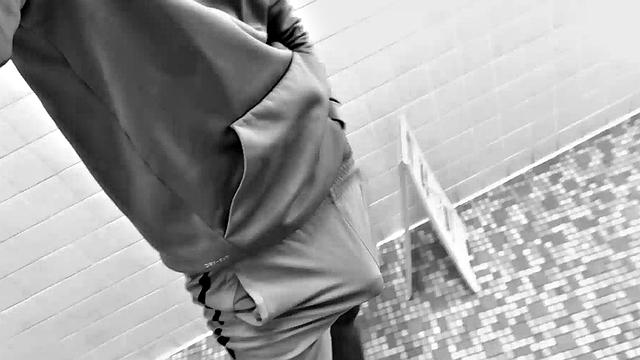 Filmed in black and white, Chris is in a public bathroom to show us his stuff. Already sporting a big boner, he drops to reveal a beautiful dick and fine ebony butt.