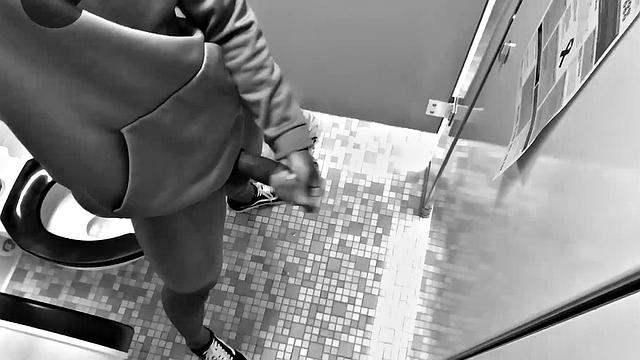 Filmed in black and white, Chris is in a public bathroom to show us his stuff. Already sporting a big boner, he drops to reveal a beautiful dick and fine ebony butt.