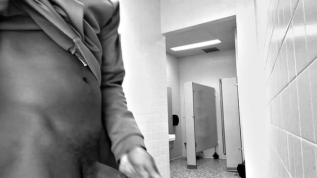 Filmed in black and white, Chris is in a public bathroom to show us his stuff. Already sporting a big boner, he drops to reveal a beautiful dick and fine ebony butt.