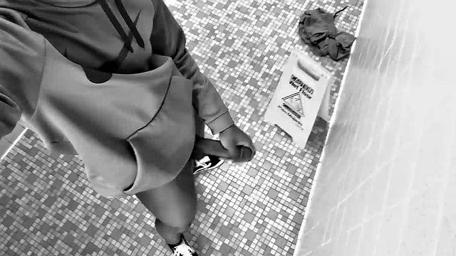 Filmed in black and white, Chris is in a public bathroom to show us his stuff. Already sporting a big boner, he drops to reveal a beautiful dick and fine ebony butt.