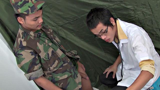 Military Asian with gaping mouth drilled by doctor