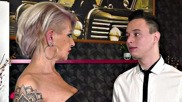 Kinky cougar in leather gets her bald pussy drilled by a big white cock