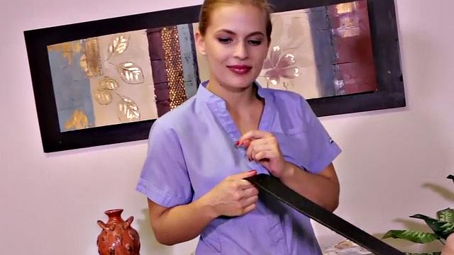 Blonde amateur in uniform with tattoos gives close-up HJ to a mean masseuse