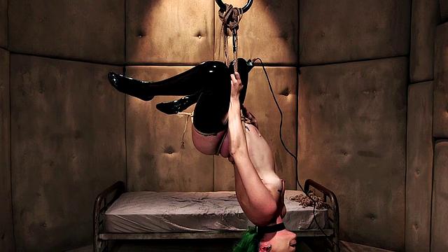 BDSM babe vibrates pussy while bound during class