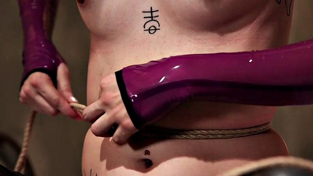 BDSM babe vibrates pussy while bound during class