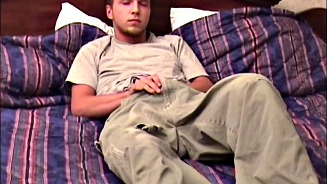 Pheonix is a sexy young man with a light beard and small patch of hair on his chest. He is the subject of Auntie Bob's next homemade video, which begins with him on the bed, working up a stiff one, as he strips naked.