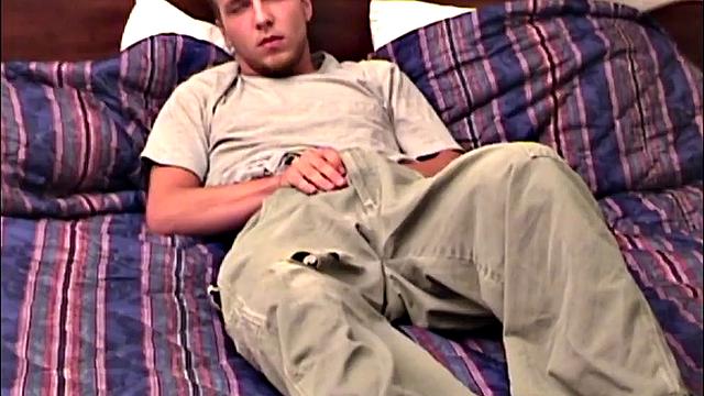 Pheonix is a sexy young man with a light beard and small patch of hair on his chest. He is the subject of Auntie Bob's next homemade video, which begins with him on the bed, working up a stiff one, as he strips naked.