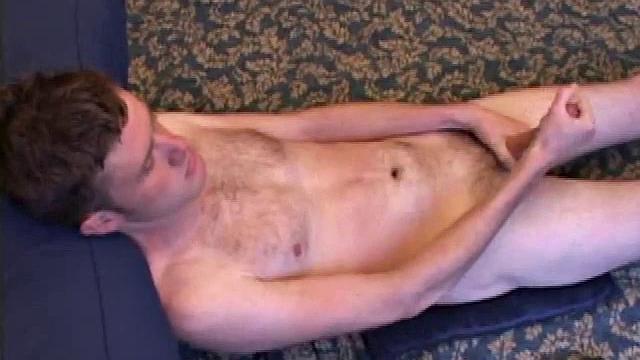 Nate Ritchie strokes his cock to full mast, his eyes glued to the porn video playing. He strokes lying down, standing up, before deciding the best way to unload is upside down.