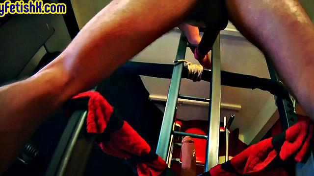 Athletic solo jock fucks his ass with machine at gym