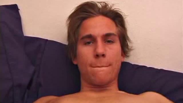 Sprawled out on the bed, Brock Labelli pulls out his cock and starts stroking. After the cameraman douses him with baby oil he continues to play with Brock's dick.