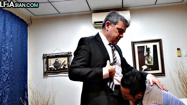 Mature business DILF fucks Asian twink in office