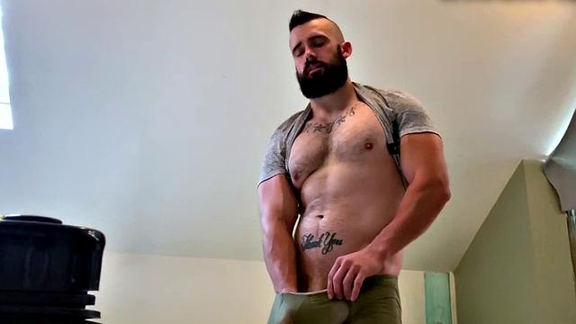 Muscular dude with tattoos jerks off and fingers his way to a hot load