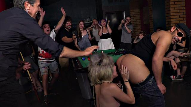 Public BDSM slut rims guy's asshole in front of voyeurs