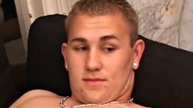 After stripping naked, Adrian Knutts works the remote control, as he strokes his cock to the porn flick that's playing. He sticks a finger up his ass to help him get closer, before shooting a big warm load onto his chest and face.