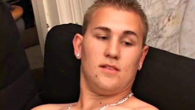 After stripping naked, Adrian Knutts works the remote control, as he strokes his cock to the porn flick that's playing. He sticks a finger up his ass to help him get closer, before shooting a big warm load onto his chest and face.