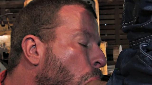 Fisting cowboy in gloves fists cocksucking bottom in the stable