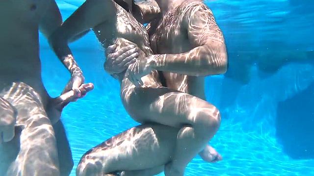 Underwater bisex outdoor 3some with oiled tits babe