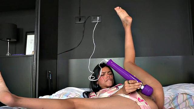 Lil Mia Holds the Vibrator with Shaved Pussy Closeup