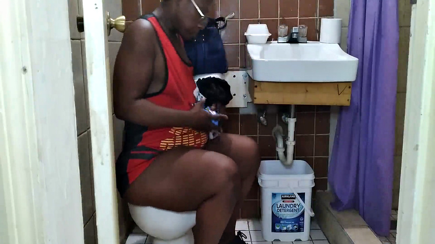 Watch this American MILF with black hair get down and dirty in the toilet