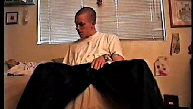 Shane undoes his baggy pants and rubs his cock while looking at a porn magazine. Rubbing the pre-cum that's appeared on his cock, he pulls off jeans and comes over to the camera.