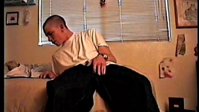 Shane undoes his baggy pants and rubs his cock while looking at a porn magazine. Rubbing the pre-cum that's appeared on his cock, he pulls off jeans and comes over to the camera.