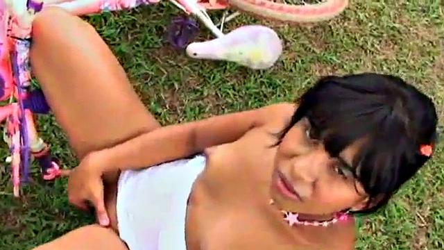 Watch this kinky teen with small tits play with her bald pussy in the open air