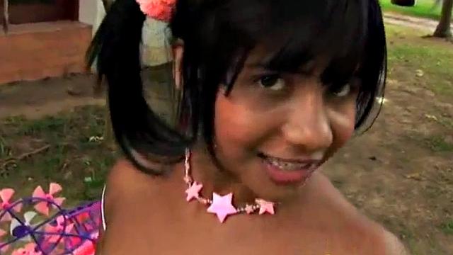 Watch this kinky teen with small tits play with her bald pussy in the open air