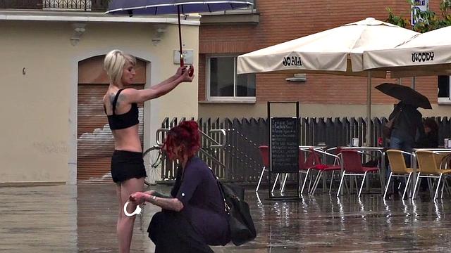 Lezdom redhead MILF shows teen servant outdoors in public
