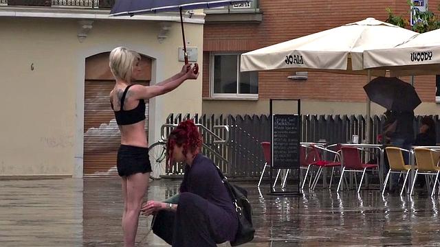 Lezdom redhead MILF shows teen servant outdoors in public