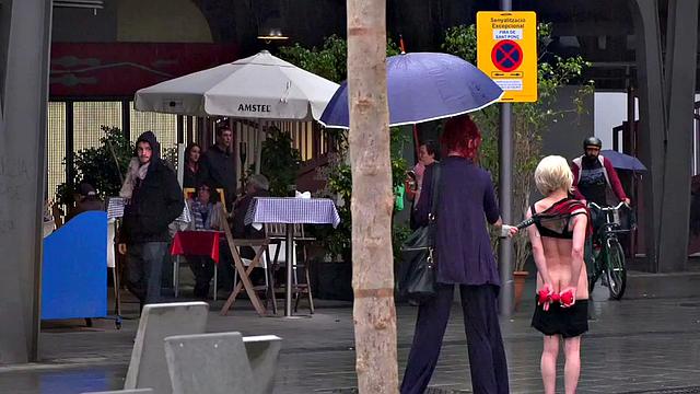 Lezdom redhead MILF shows teen servant outdoors in public