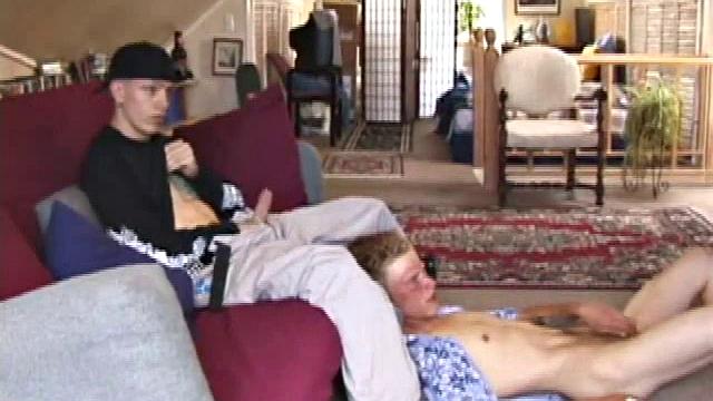 Brandon sits on the floor and rubs the growing bulge in his pants while he watches some bimbos on the TV. Shane comes up the stairs and notices that Brandon is already hard at work and sits down on the couch behind him.