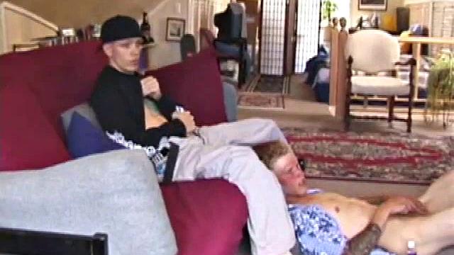 Brandon sits on the floor and rubs the growing bulge in his pants while he watches some bimbos on the TV. Shane comes up the stairs and notices that Brandon is already hard at work and sits down on the couch behind him.