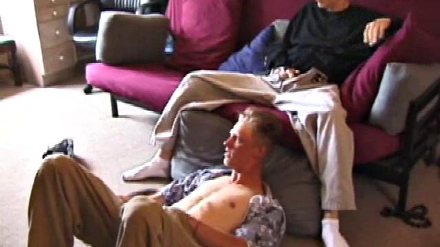 Brandon sits on the floor and rubs the growing bulge in his pants while he watches some bimbos on the TV. Shane comes up the stairs and notices that Brandon is already hard at work and sits down on the couch behind him.