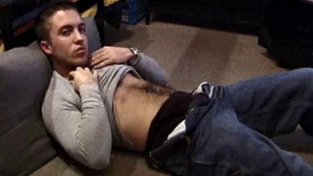 Johnny Johnson starts a porn video. Revealing his hairy chest, this young man sticks his hand down his jeans and massages his cock. This boy has big arms and a big dick that he loves to show off.