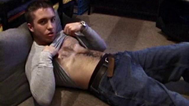 Johnny Johnson starts a porn video. Revealing his hairy chest, this young man sticks his hand down his jeans and massages his cock. This boy has big arms and a big dick that he loves to show off.