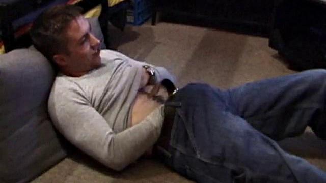 Johnny Johnson starts a porn video. Revealing his hairy chest, this young man sticks his hand down his jeans and massages his cock. This boy has big arms and a big dick that he loves to show off.