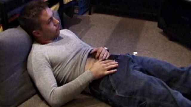 Johnny Johnson starts a porn video. Revealing his hairy chest, this young man sticks his hand down his jeans and massages his cock. This boy has big arms and a big dick that he loves to show off.