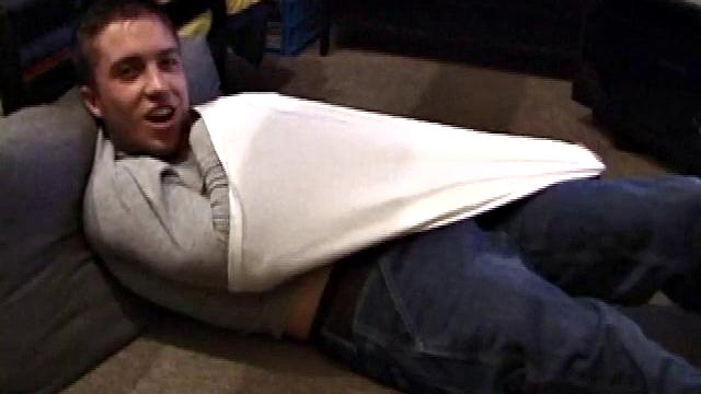 Johnny Johnson starts a porn video. Revealing his hairy chest, this young man sticks his hand down his jeans and massages his cock. This boy has big arms and a big dick that he loves to show off.