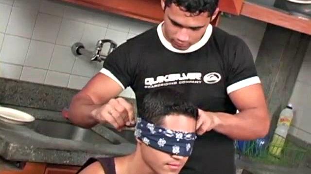 Carlos de Olivira is surprised by his buff friend Paulo Colimbra with a blindfold and a  candle on a cake.