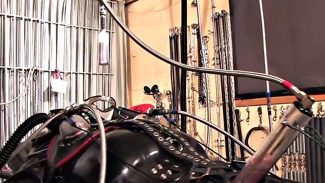 Femdom latex domina torments sub with cock pump
